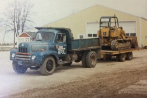 {"OL'-BLUE" DUMP TRUCK, ONE OF THE FIRSTS USED BY THE COMPANY}